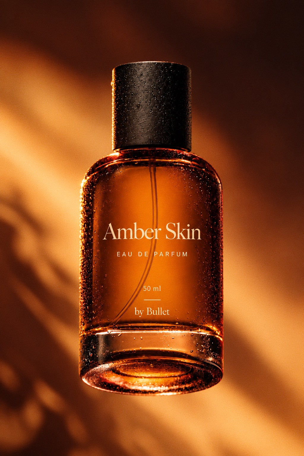 A 50 ml bottle of Amber Skin Eau De Parfum by Bullet, featuring amber-colored liquid in a clear glass bottle with a textured black cap, set against a warm, shadowed golden-brown background.